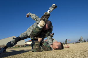 Staff Sgt. Christopher Davidson, a military training instructor, demonstrates proper grappling procedures with an officer trainee Feb. 8 during the new Air Force Combative Program field exercise at the Officer Training School at Maxwell Air Force Base, Montgomery, Ala. All officer accession students are being given 11 hours of combative-skills training. Trainees learn ground fighting and basic jujitsu-style grappling moves to provide them with the confidence they need to defend themselves in combat situations. (U.S. Air Force photo/Staff Sgt. Bennie J. Davis III) Close Quarter Combat