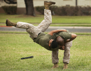 Sgt. Robert Hernandez, a black belt Marine Corps Martial Arts Program instructor with the School of Infantry West — Detachment Hawaii, performs a hip throw on fellow instructor Sgt. Joaquin Recuero, a flight line equipment mechanic with Marine Heavy Helicopter Squadron 363, during a MCMAP second degree advancement and re-certification workshop held by a mobile training team from the Marine Corps Martial Arts Center of Excellence on Marine Corps Base Hawaii, April 11. The team of top-level MACE instructors, coming to Hawaii from the Marine Corps' MCMAP hub in Quantico, Va., offered more than 40 Hawaii-based Marines the opportunity to renew their three-year certifications as MCMAP instructors and instructor-trainers, and advance their belts to the second degree during the week-long workshop. Close Quarter Combat